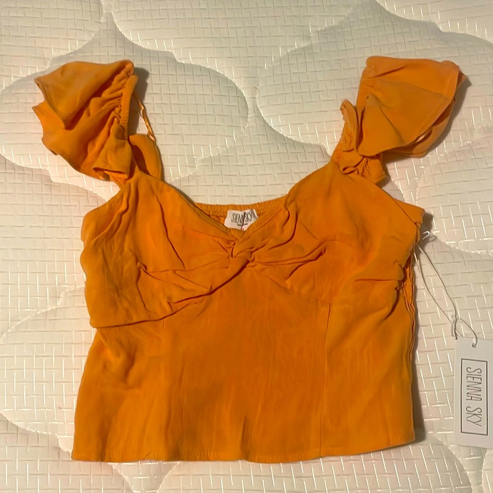 A cute orange top perfect for every day where